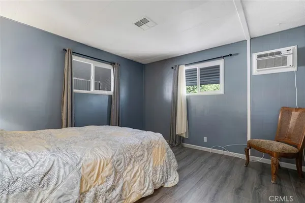 a bedroom with a bed and a chair