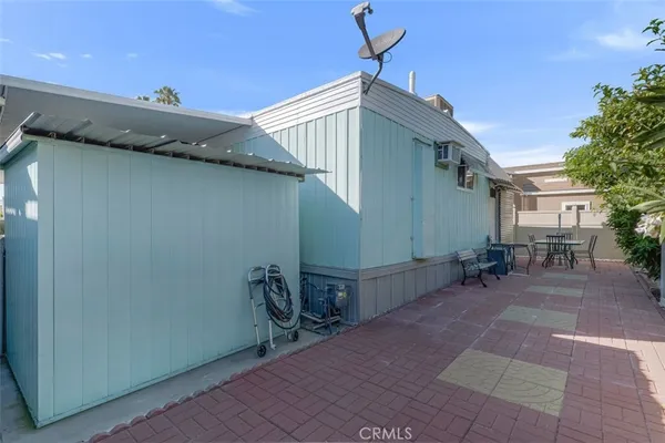 a backyard of a house with table and chairs