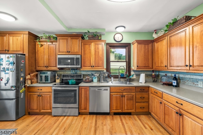 886 Brass Castle Road Belvidere, NJ 07823 - Photo 12 of 44 a kitchen with stainless steel appliances a sink cabinets wooden floor and a window