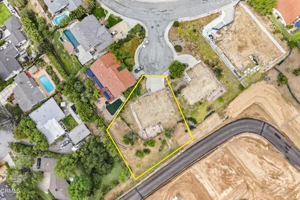 an aerial view of a house with a swimming pool and outdoor seating