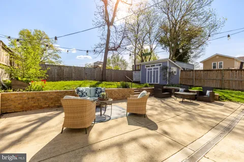 a view of a patio with couches and a fire pit