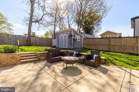 a view of a backyard with couches table and chairs