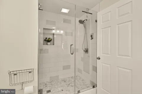 a bathroom with a shower and a glass door