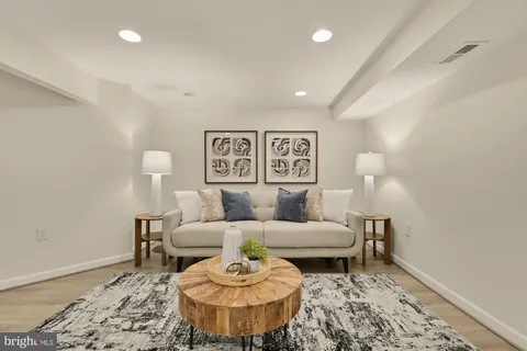 a living room with furniture and wooden floor