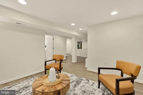 a living room with furniture and a mirror