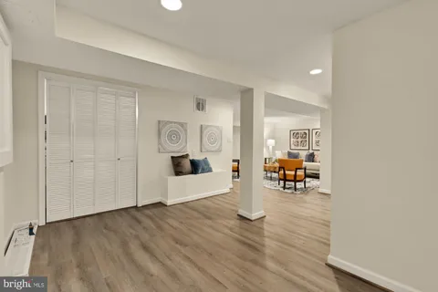 a view of living room filled with furniture and wooden floor