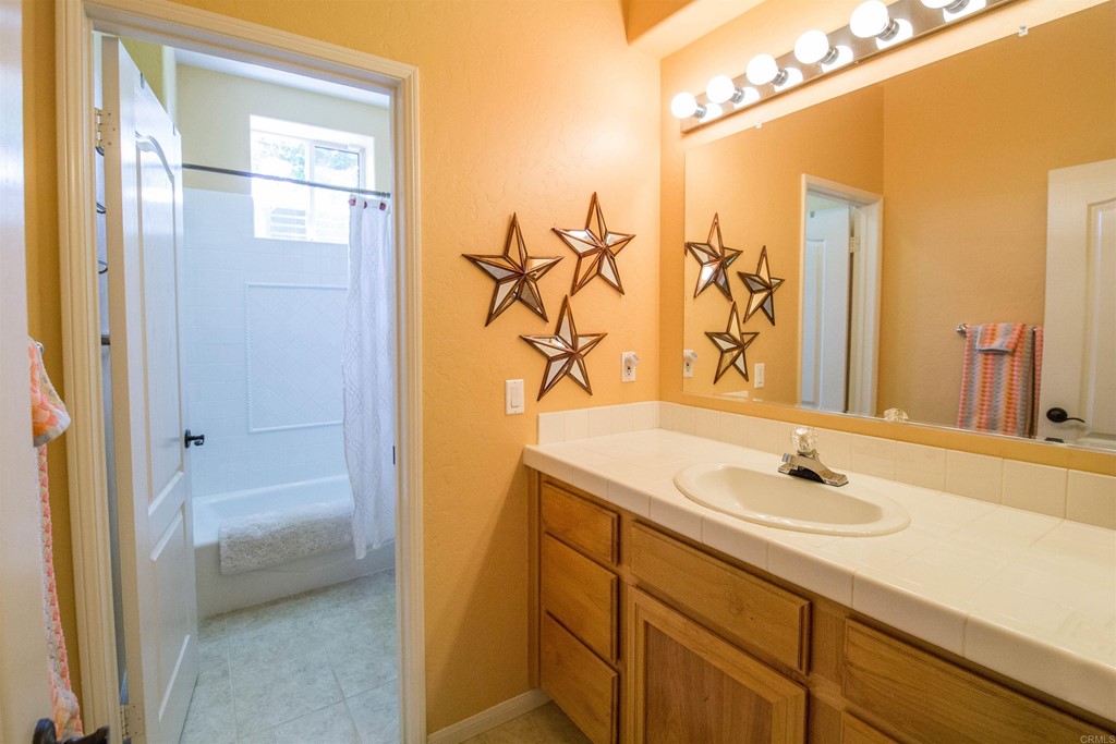 1793 Rocrest Road Alpine, CA 91901 - Photo 48 of 63 a bathroom with a sink and a mirror
