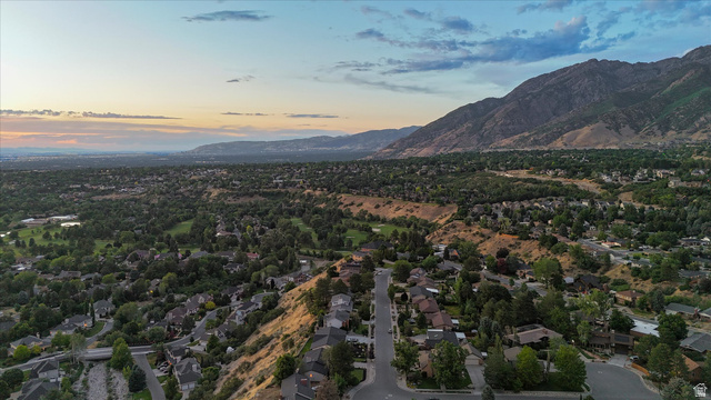 8760 Rustler Road Cottonwood Heights, UT 84093 - Photo 52 of 57 Aerial perspective of a verdant residential area featuring mature trees, paved streets, and mountainous terrain