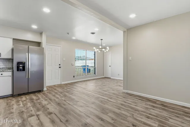 a view of a kitchen with a refrigerator and a sink