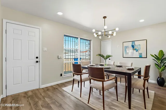 a view of a dining room with furniture and chandelier