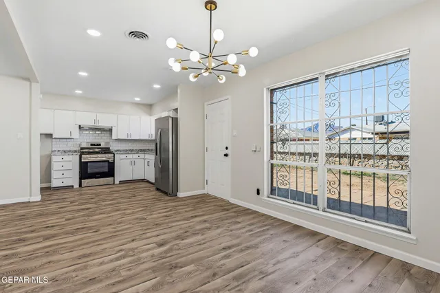 a view of a kitchen with a stove cabinets and wooden floor