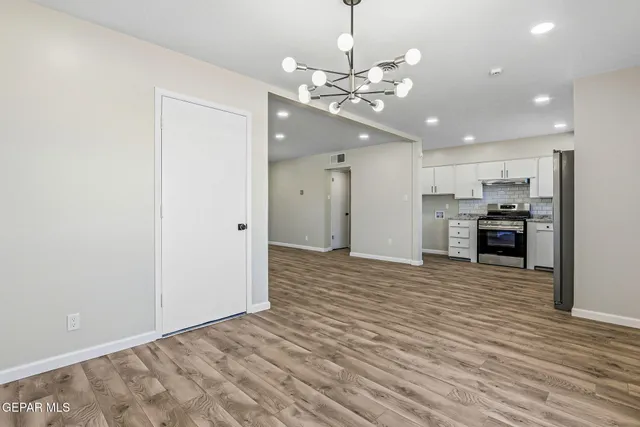 a view of a kitchen with a sink and refrigerator