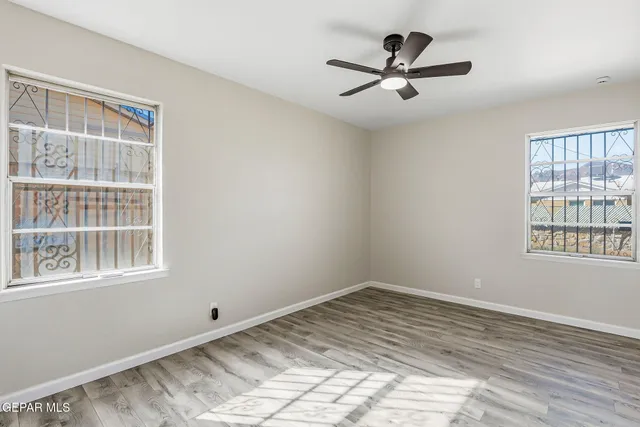 a view of a room with wooden floor and a window