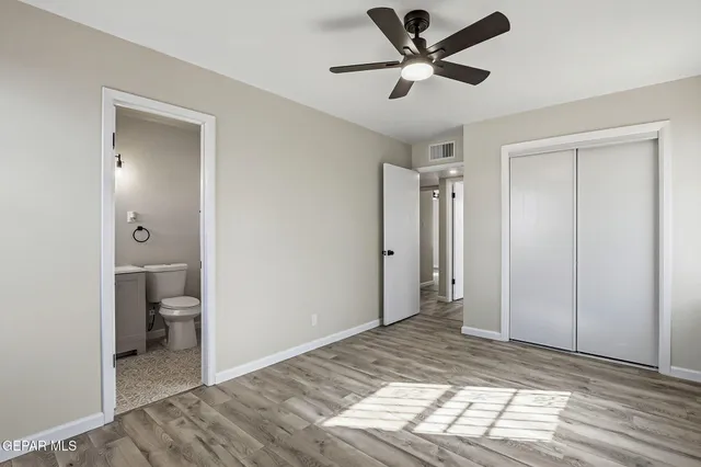 a view of a big room with wooden floor and a bathroom