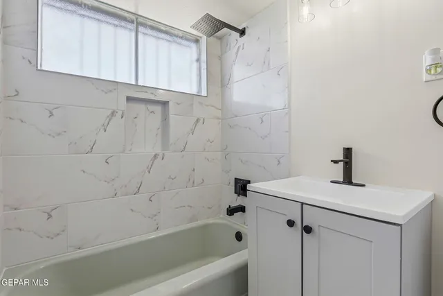 a bathroom with a bathtub and a shower