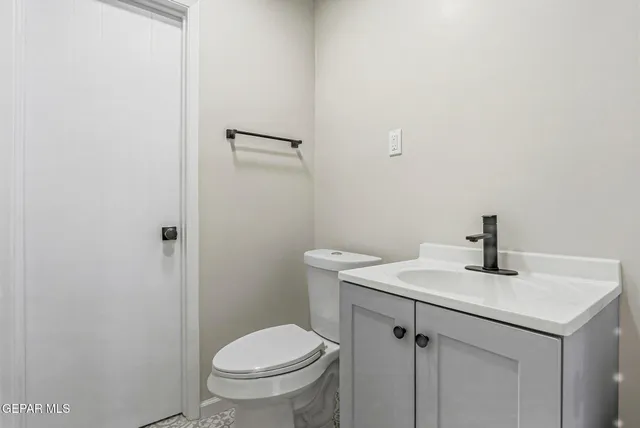 a bathroom with a sink a toilet and vanity