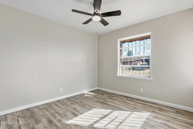 a view of a room with window and ceiling fan