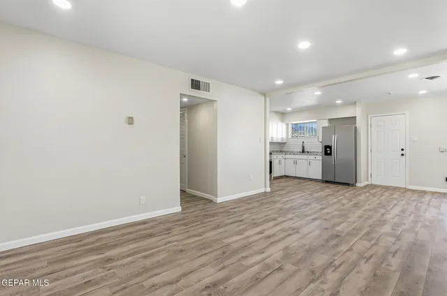 a view of a kitchen with wooden floor