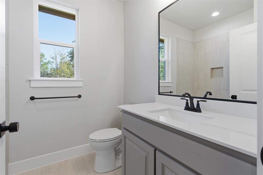 328 Rita Ridge Millsap, TX 76066 - Photo 19 of 27 a bathroom with a sink a toilet and a mirror
