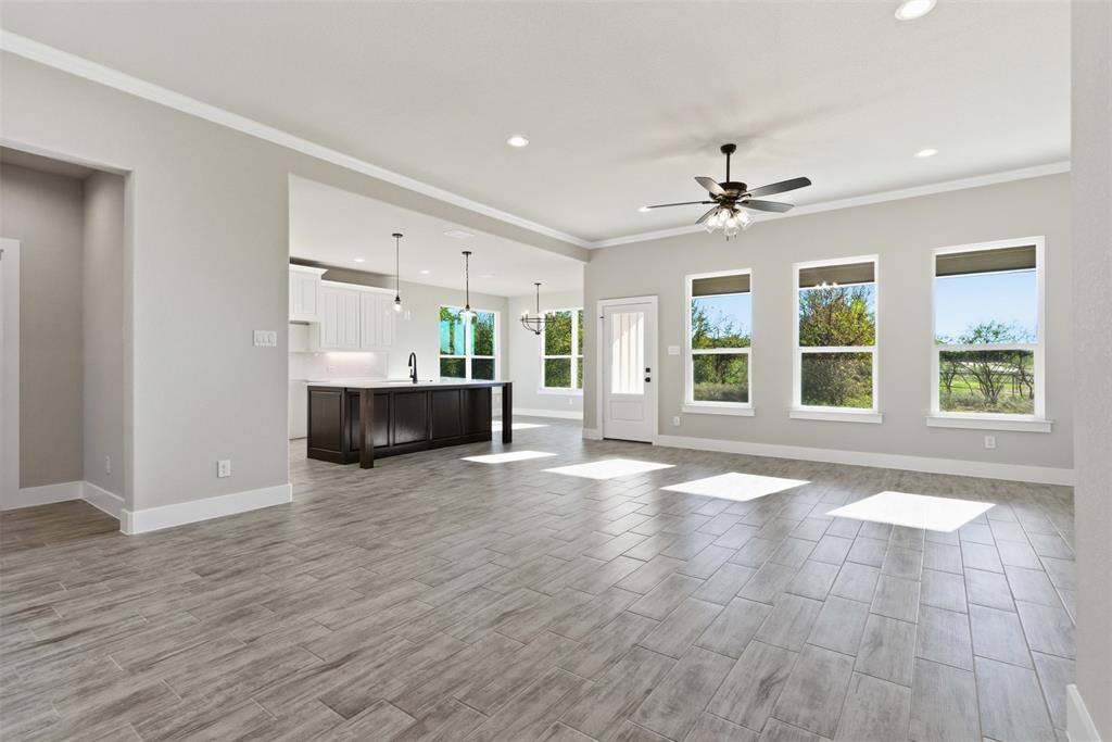 328 Rita Ridge Millsap, TX 76066 - Photo 4 of 27 a view of an empty room with a window and kitchen view