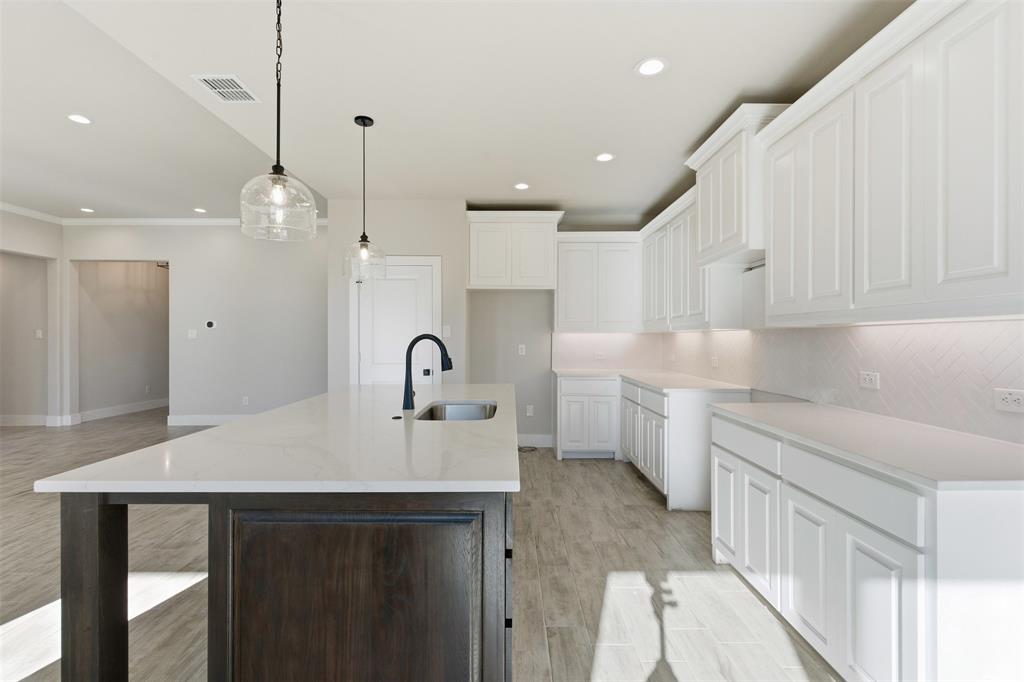 328 Rita Ridge Millsap, TX 76066 - Photo 10 of 27 a kitchen with kitchen island a sink appliances and cabinets