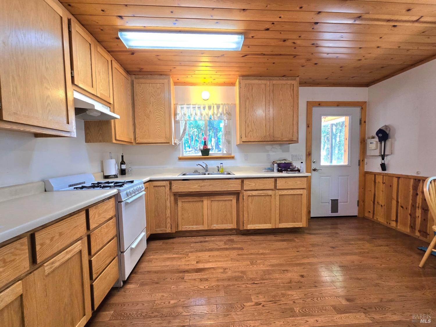 36193 Covelo Road Willits, CA 95490 - Photo 10 of 30 a kitchen with stainless steel appliances granite countertop a sink a stove cabinets counter space and a window