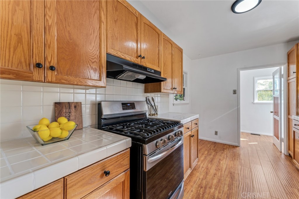 2452 Riverside Place Los Angeles, CA 90039 - Photo 4 of 13 a kitchen with a sink a stove and cabinets