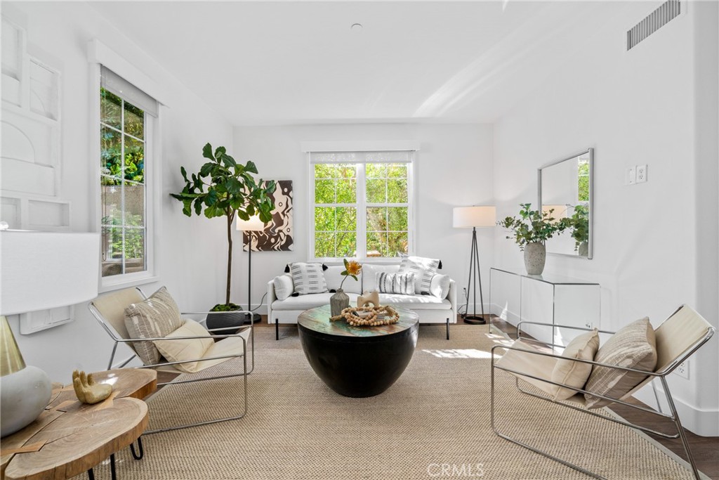 a living room with furniture and a potted plant