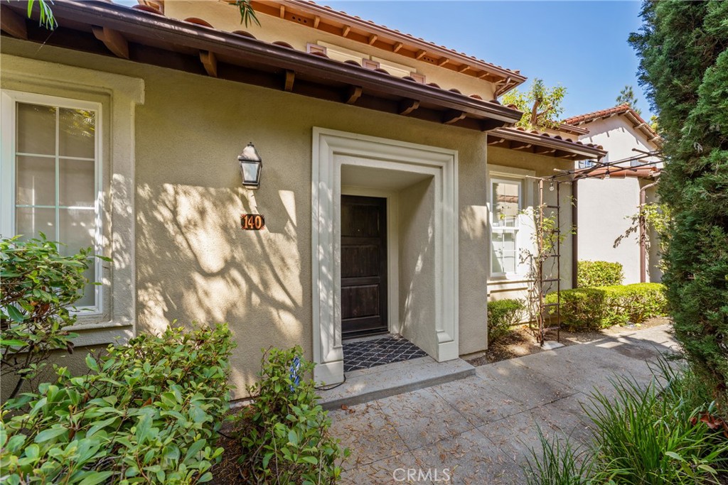 140 White Flower Irvine, CA 92603 - Photo 2 of 44 a front view of a house with a garden