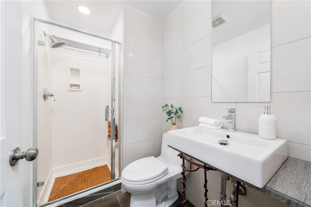 140 White Flower Irvine, CA 92603 - Photo 21 of 44 a bathroom with a sink toilet and shower