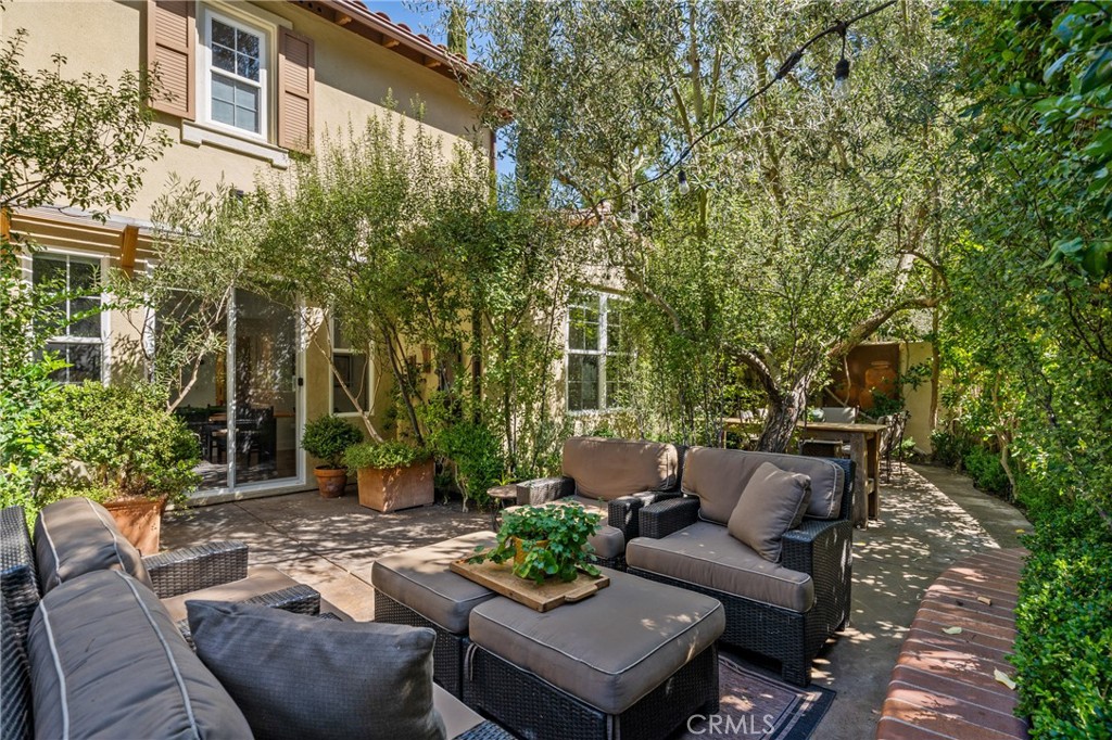 140 White Flower Irvine, CA 92603 - Photo 26 of 44 a view of a patio with couches and a fire pit and wooden fence
