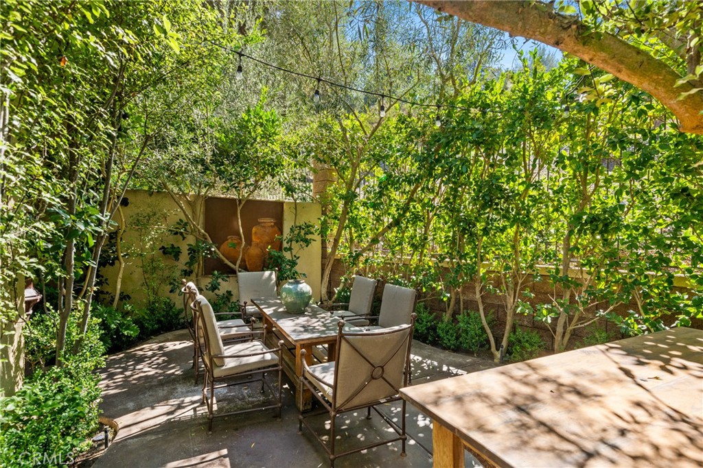 140 White Flower Irvine, CA 92603 - Photo 27 of 44 a view of a patio with table and chairs with wooden fence and plants