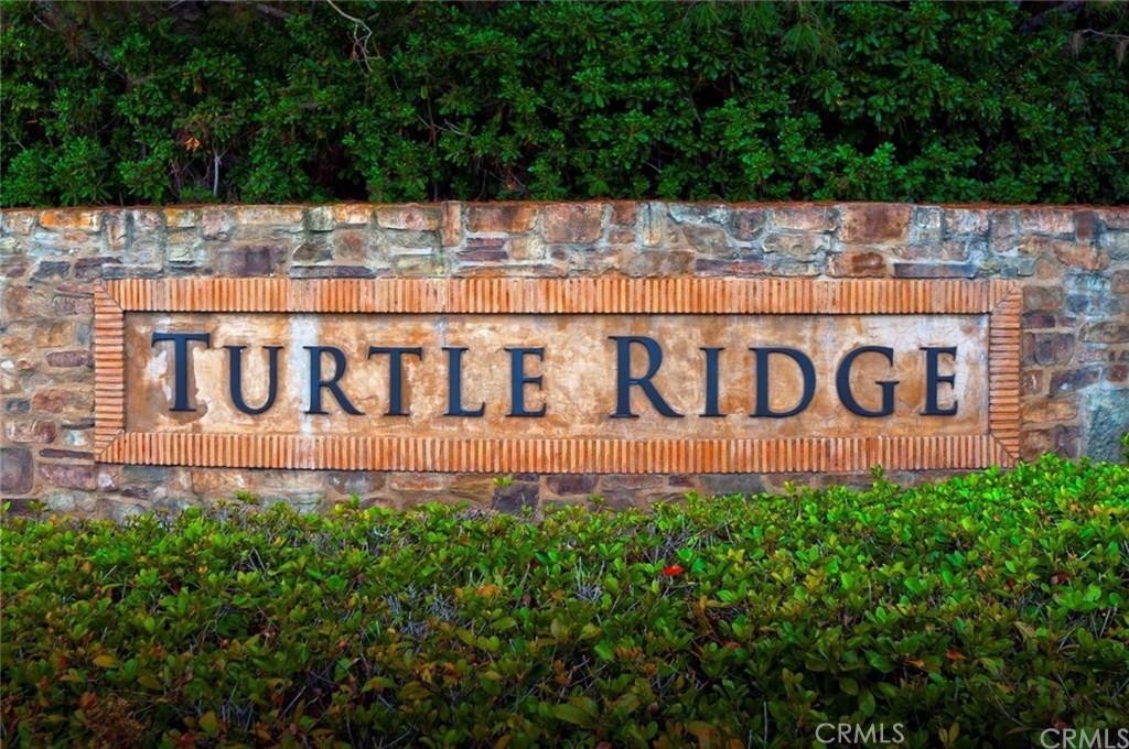 140 White Flower Irvine, CA 92603 - Photo 34 of 44 a view of sign board with yard and buildings in the background