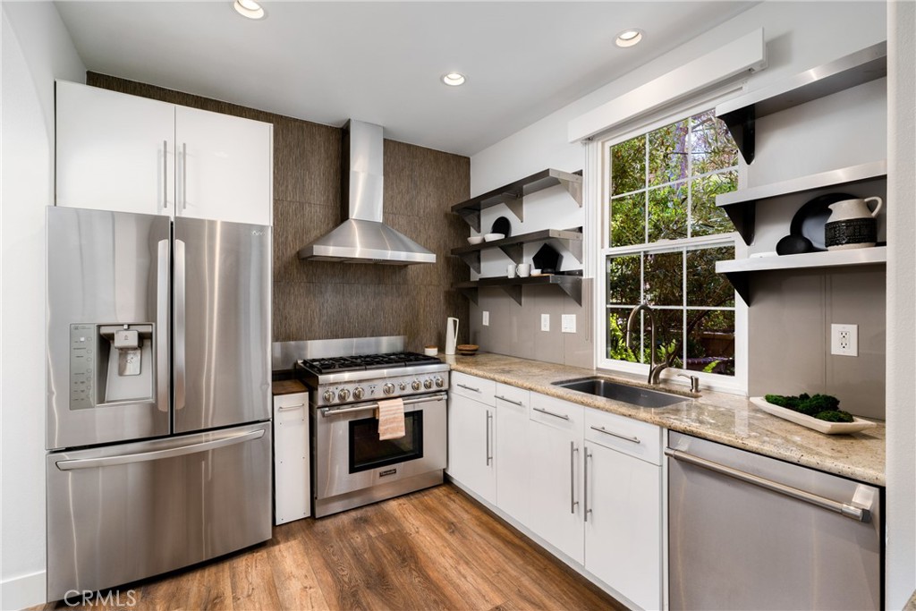 140 White Flower Irvine, CA 92603 - Photo 8 of 44 a kitchen with stainless steel appliances a refrigerator sink and cabinets