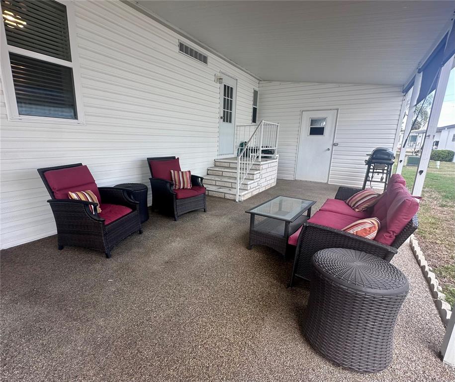 1100 South Belcher Road, Unit 406 Largo, FL 33771 - Photo 20 of 46 a living room with furniture and a wooden floor