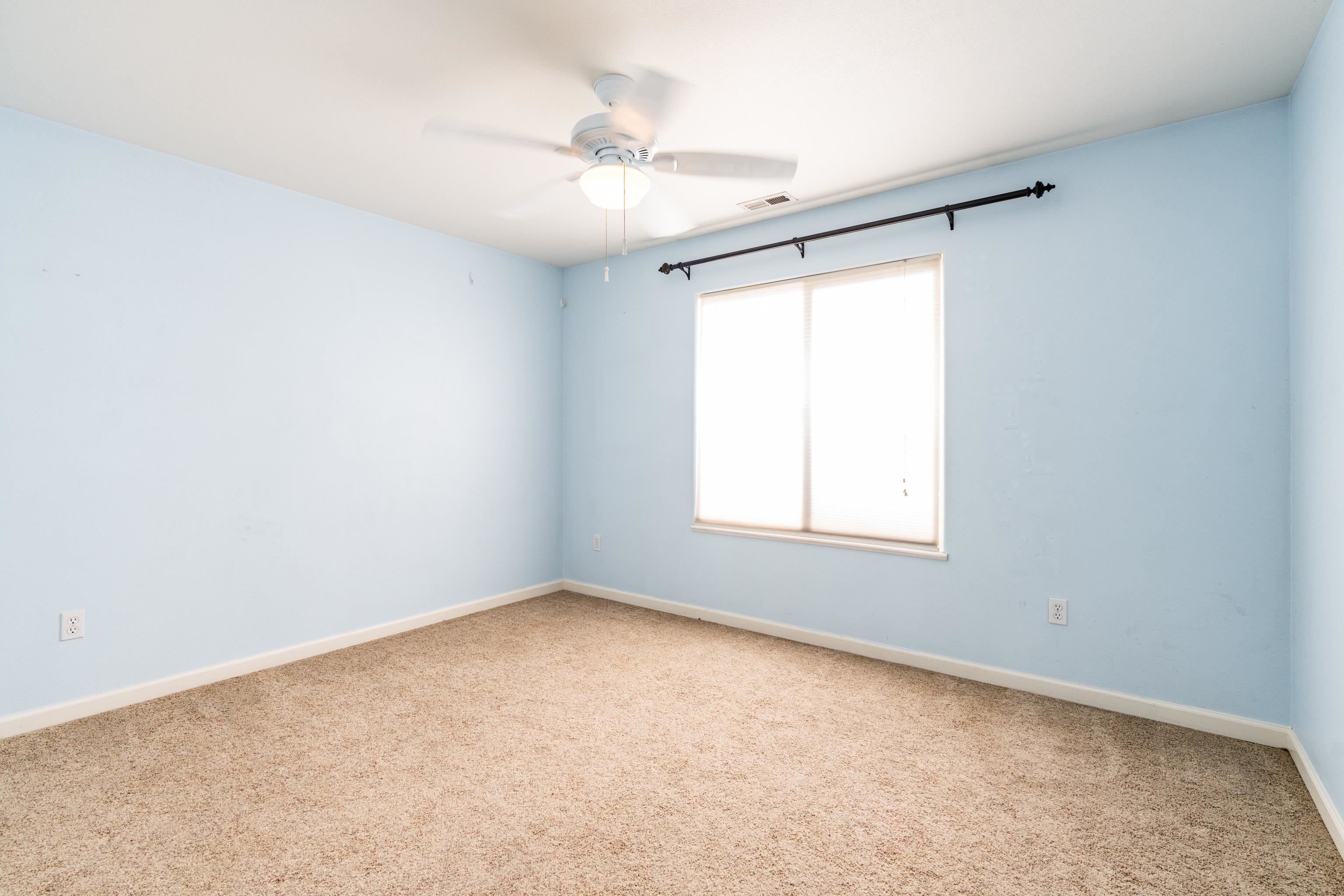 653 Hall Street Fruita, CO 81521 - Photo 14 of 25 an empty room with a window and a fan