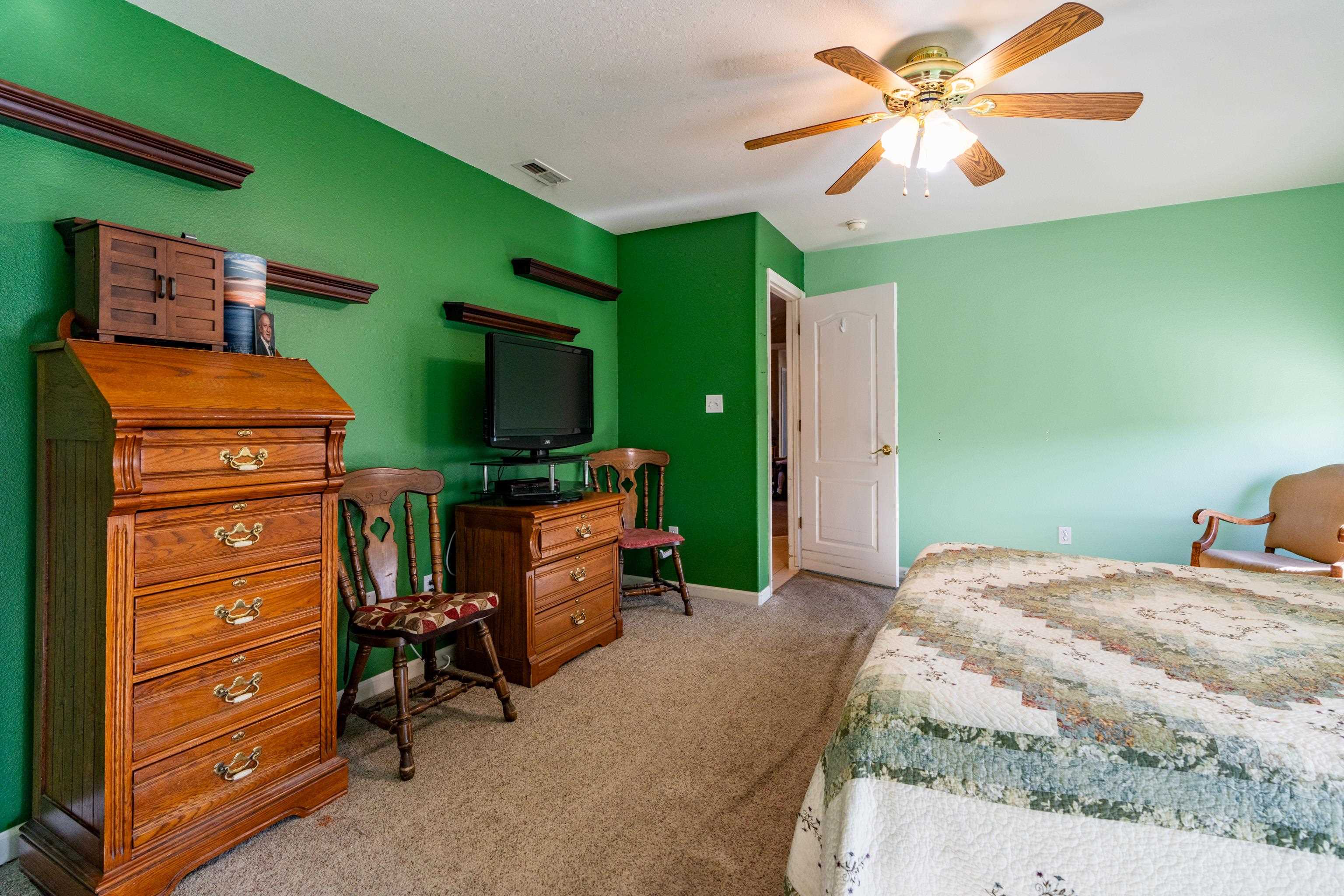 653 Hall Street Fruita, CO 81521 - Photo 18 of 25 a bedroom with a bed and a mirror on the dresser