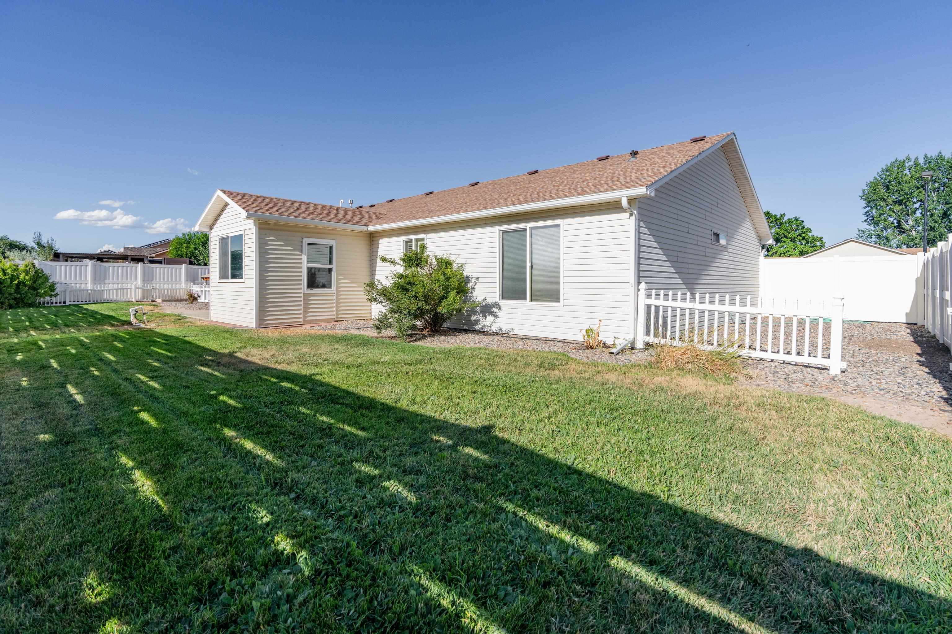 653 Hall Street Fruita, CO 81521 - Photo 2 of 25 a front view of house with yard and green space
