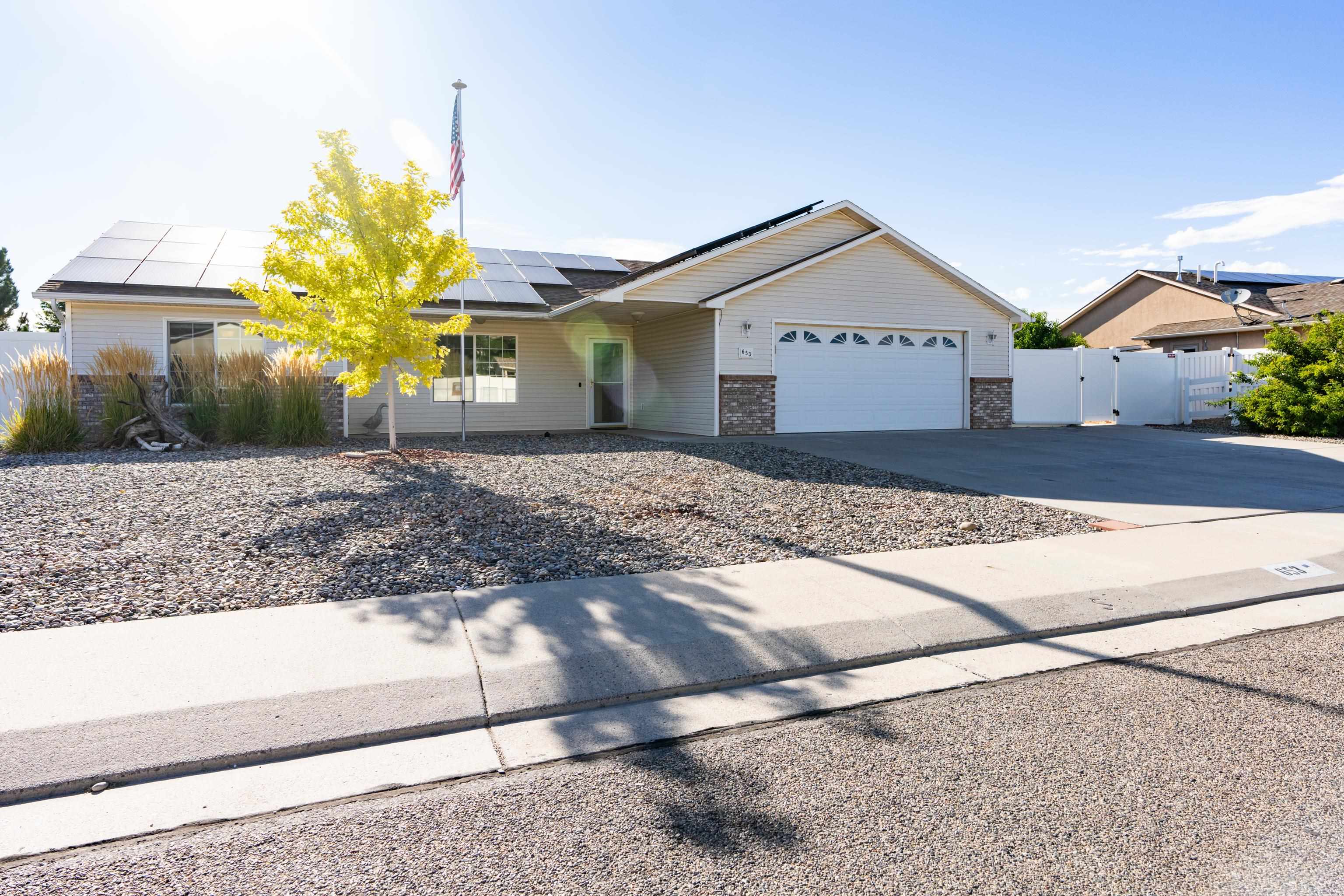 653 Hall Street Fruita, CO 81521 - Photo 25 of 25 a view of a house with a yard and garage