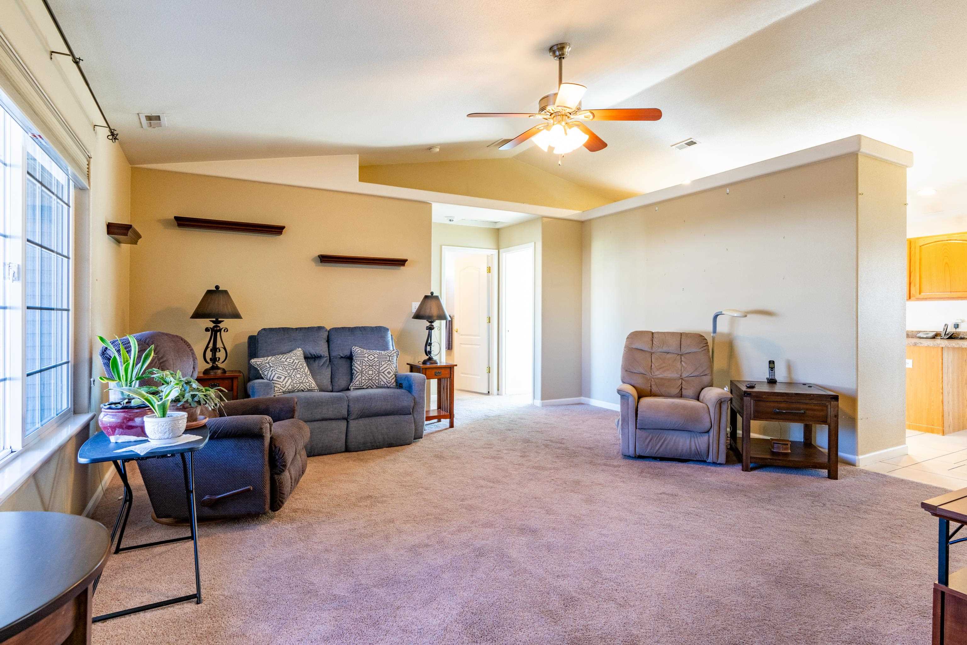 653 Hall Street Fruita, CO 81521 - Photo 3 of 25 a living room with furniture and a chandelier