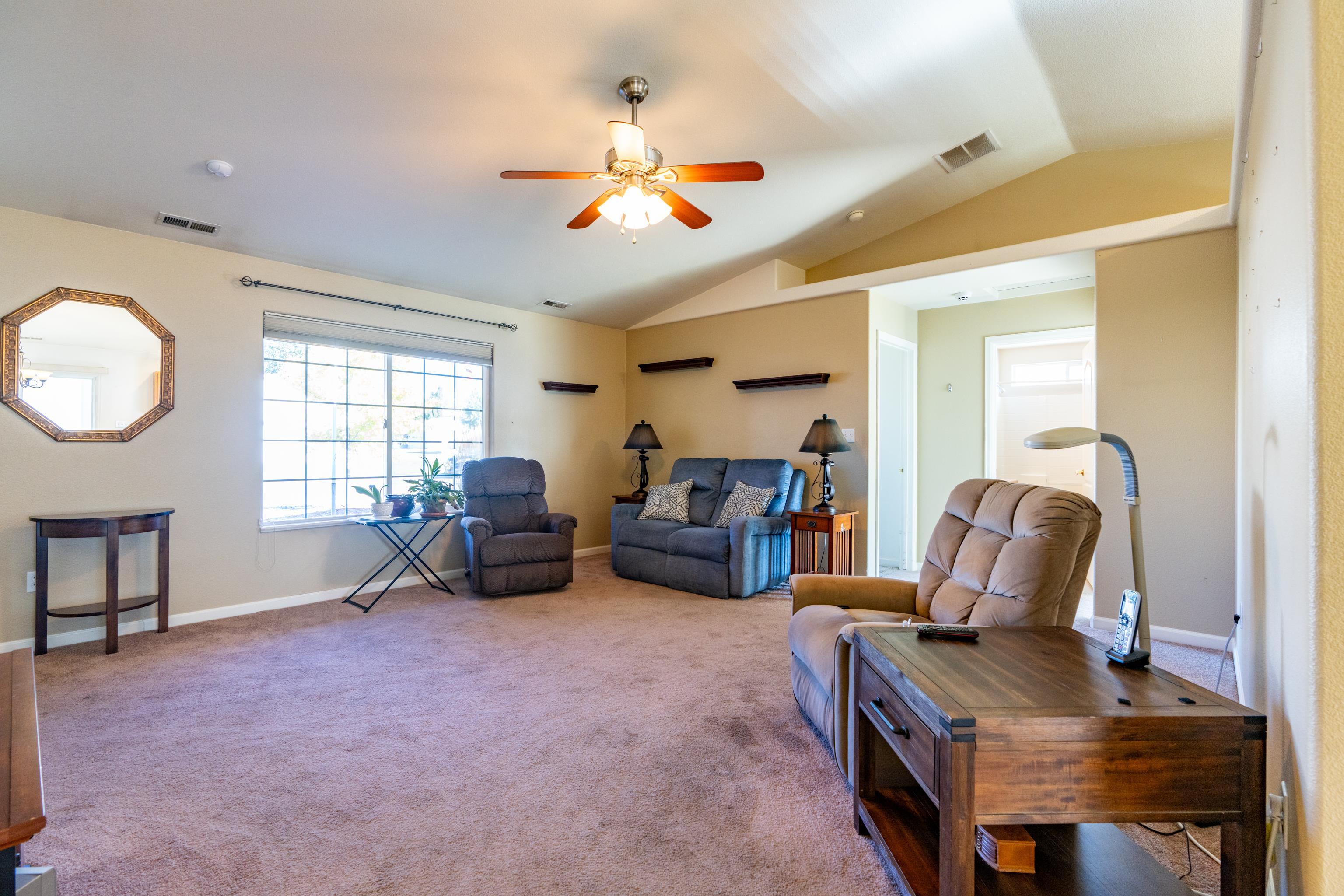 653 Hall Street Fruita, CO 81521 - Photo 4 of 25 a living room with furniture a couch and a window