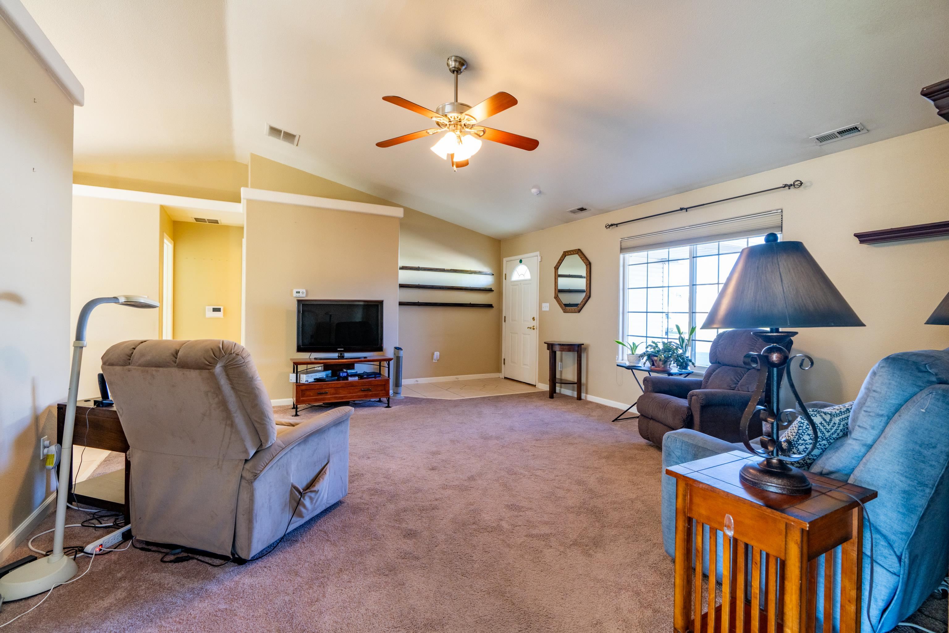 653 Hall Street Fruita, CO 81521 - Photo 5 of 25 a living room with furniture and a flat screen tv