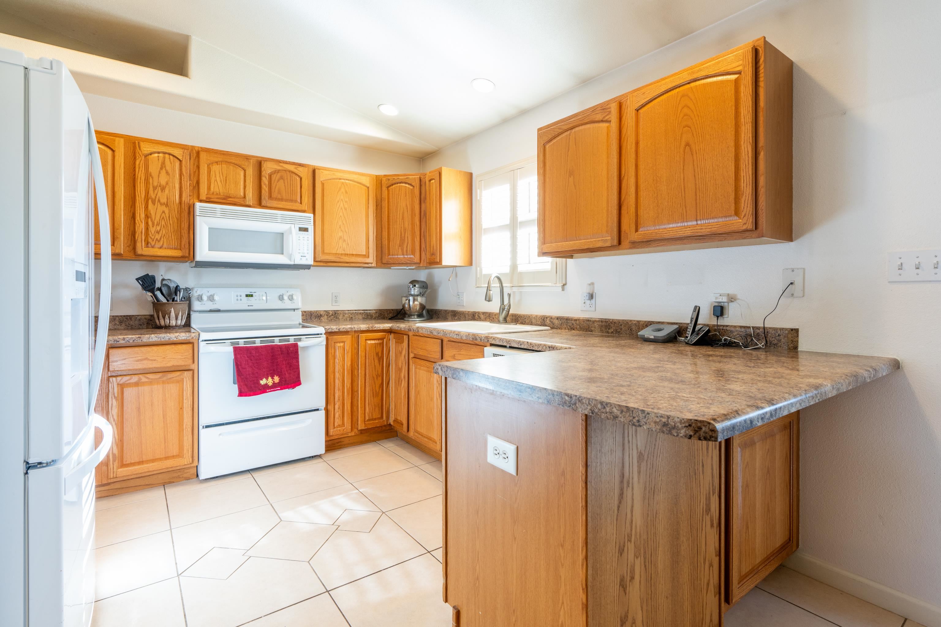 653 Hall Street Fruita, CO 81521 - Photo 8 of 25 a kitchen with granite countertop a sink and a stove