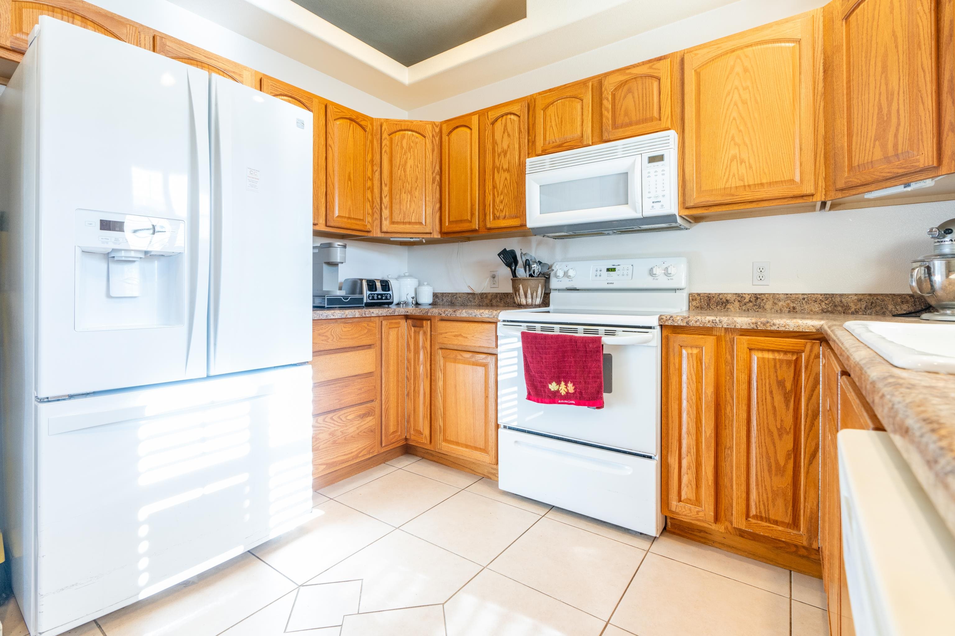 653 Hall Street Fruita, CO 81521 - Photo 10 of 25 a kitchen with stainless steel appliances granite countertop a stove a sink and a refrigerator