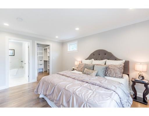 2 Raynor Road Weston, MA 02493 - Photo 17 of 26 a bedroom with a large bed and a wooden floor