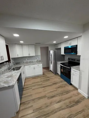 a kitchen with a sink stove and refrigerator