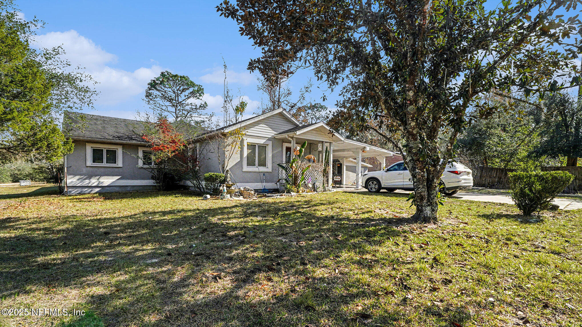 130 Lakeview Way Interlachen, FL 32148 - Photo 2 of 29 a front view of a house with a yard tree and outdoor seating