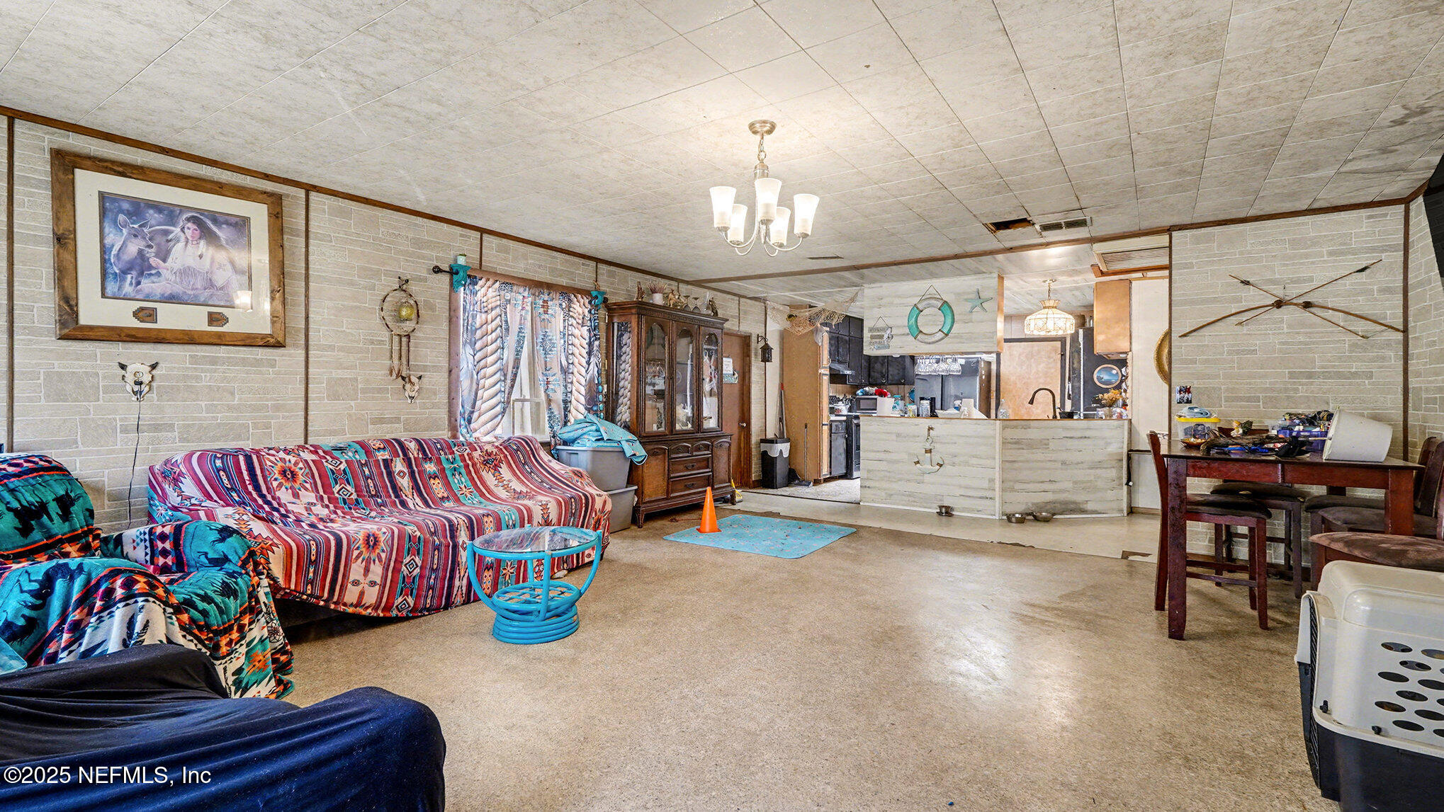 130 Lakeview Way Interlachen, FL 32148 - Photo 5 of 29 a living room with lots of furniture and a chandelier