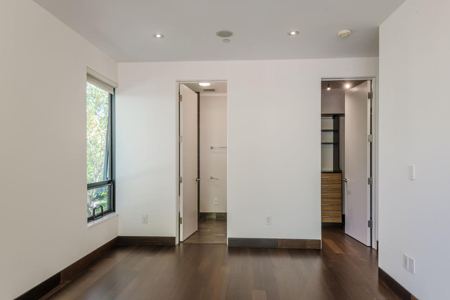 2510 Skyfarm Drive Hillsborough, CA 94010 - Photo 24 of 66 an empty room with wooden floor and windows