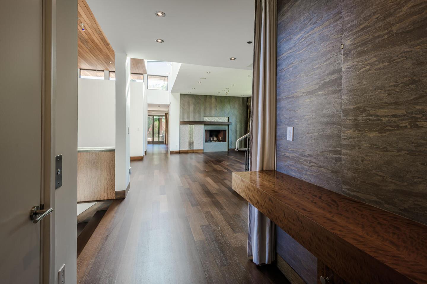 2510 Skyfarm Drive Hillsborough, CA 94010 - Photo 30 of 66 a view of a hallway with wooden floor fireplace and windows